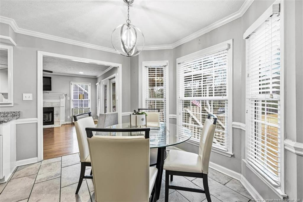 403 Lionshead Road Fayetteville, NC 28311 - Photo 11 of 49 a dining room with furniture a chandelier and wooden floor
