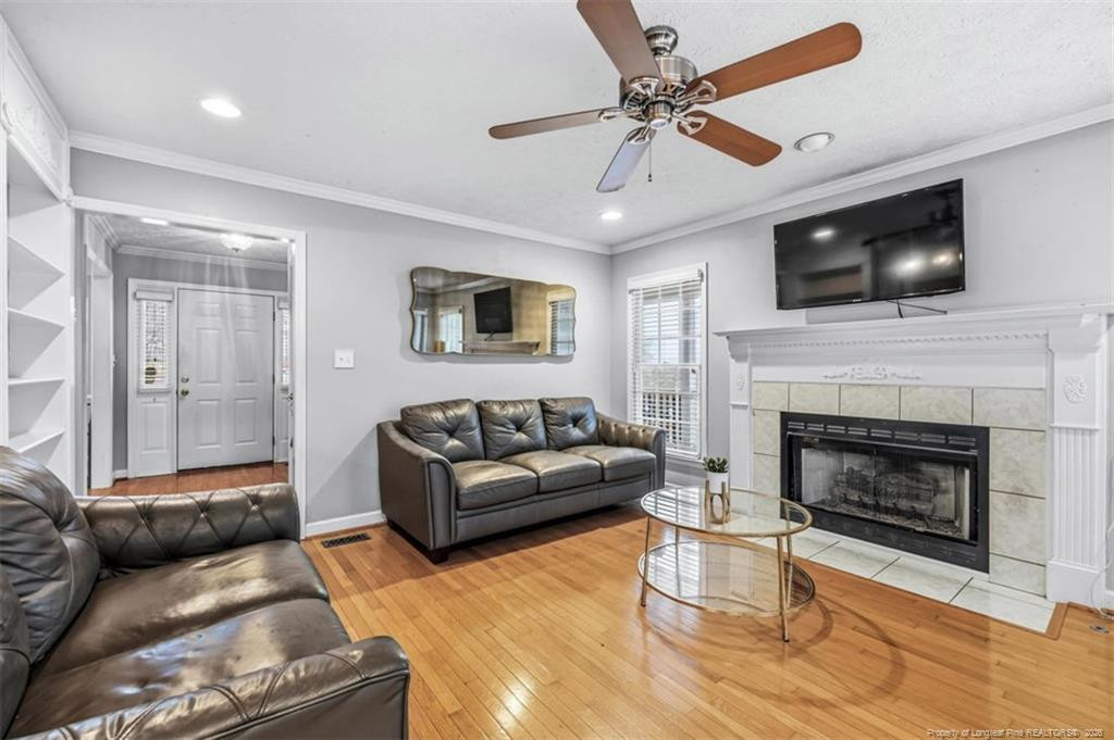 403 Lionshead Road Fayetteville, NC 28311 - Photo 15 of 49 a living room with furniture a flat screen tv and a fireplace