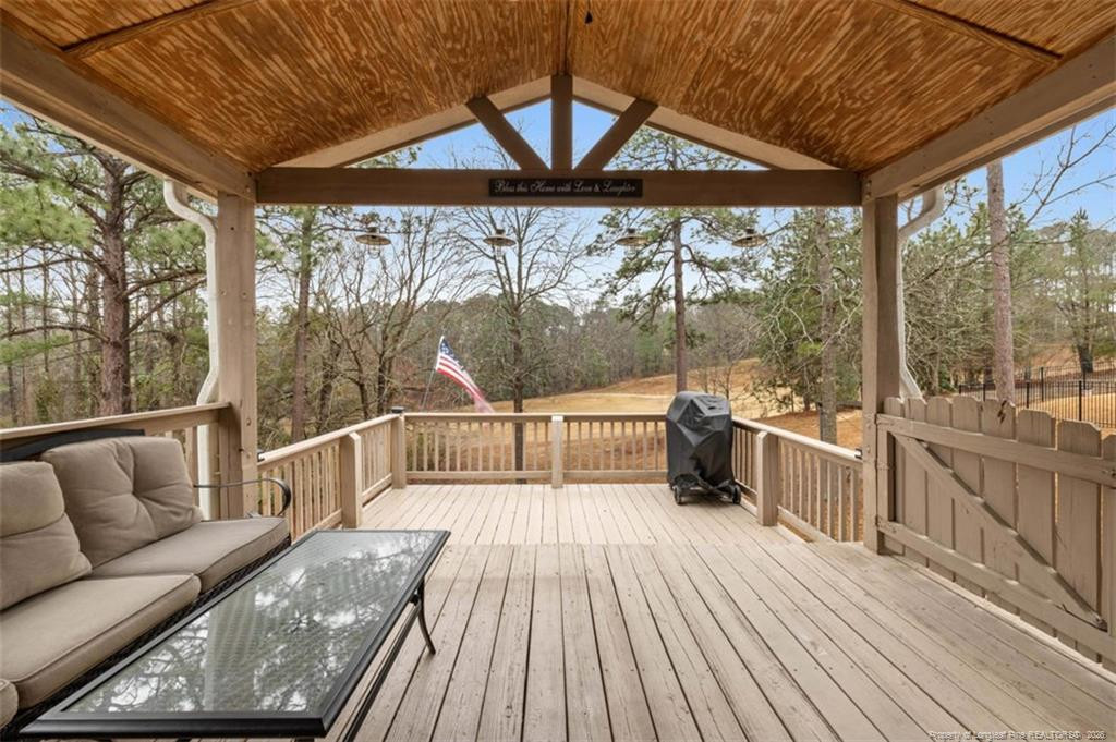 403 Lionshead Road Fayetteville, NC 28311 - Photo 19 of 49 a view of a balcony with couch and wooden floor