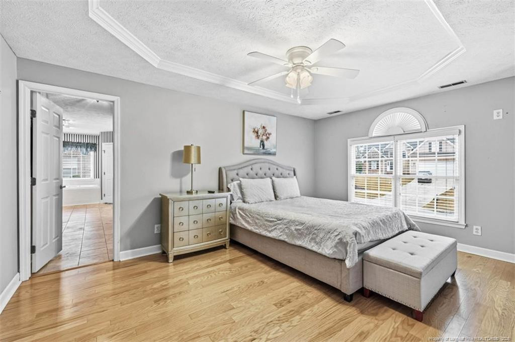 403 Lionshead Road Fayetteville, NC 28311 - Photo 21 of 49 a spacious bedroom with a large bed and a chandelier