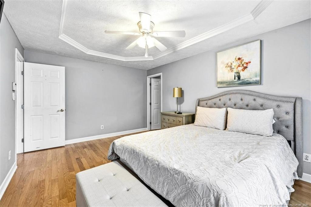 403 Lionshead Road Fayetteville, NC 28311 - Photo 22 of 49 a bedroom with a large bed and a chandelier