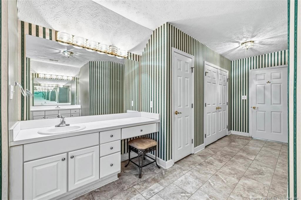 403 Lionshead Road Fayetteville, NC 28311 - Photo 26 of 49 a spacious bathroom with a shower sink and mirror