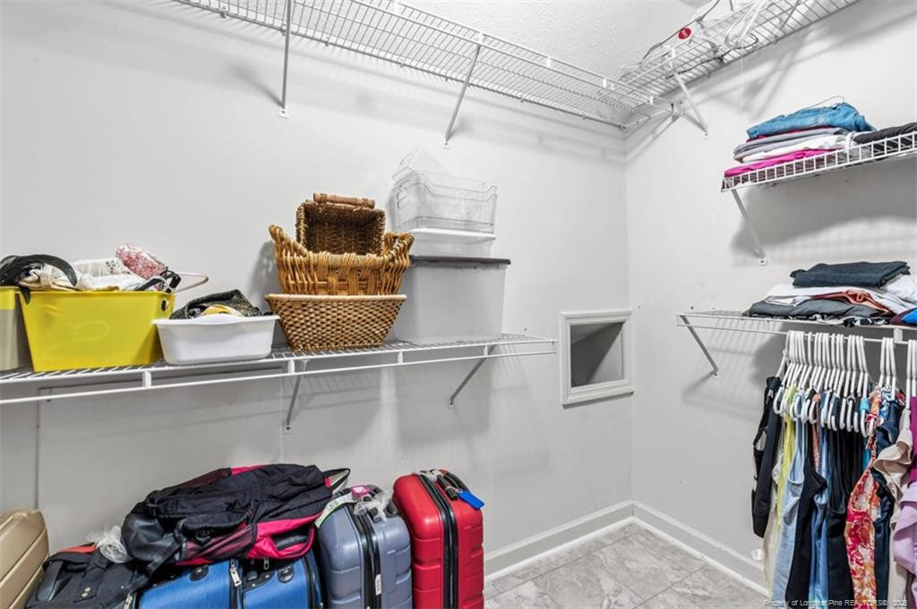 403 Lionshead Road Fayetteville, NC 28311 - Photo 28 of 49 a view of walk in closet with clothes and shoes