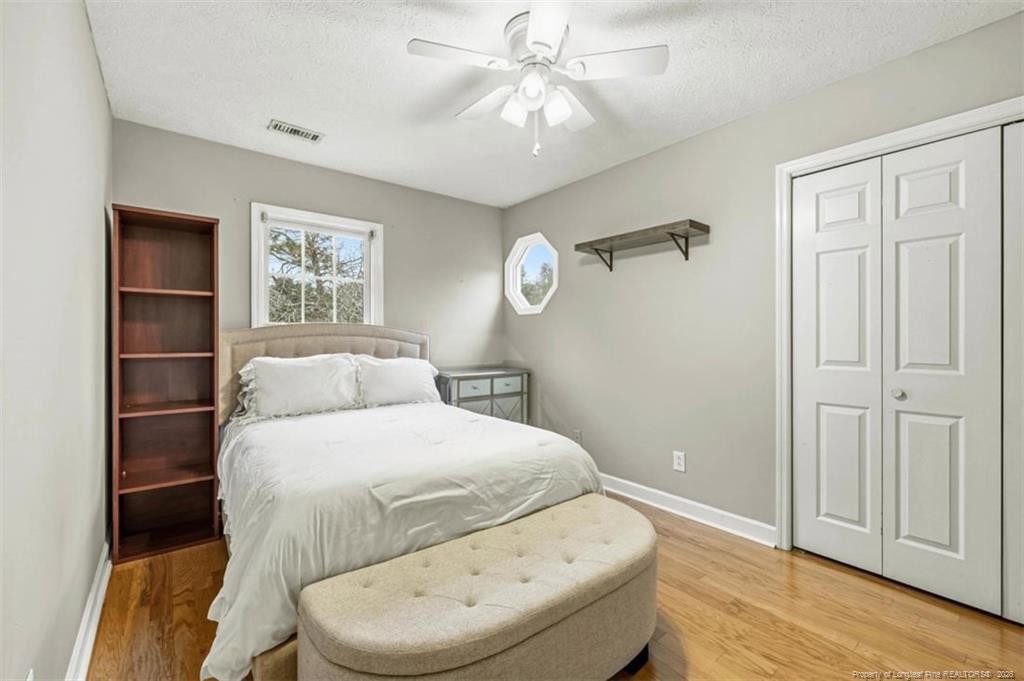 403 Lionshead Road Fayetteville, NC 28311 - Photo 29 of 49 a bedroom with a bed and a chandelier
