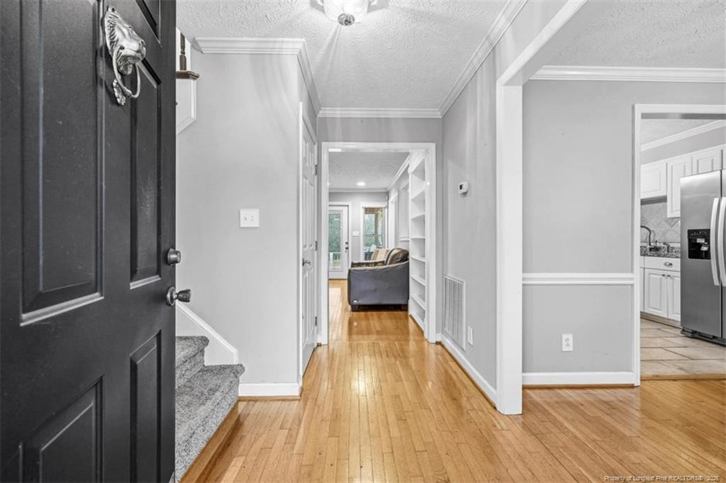 403 Lionshead Road Fayetteville, NC 28311 - Photo 3 of 49 a view of a hallway view with wooden floor and staircase