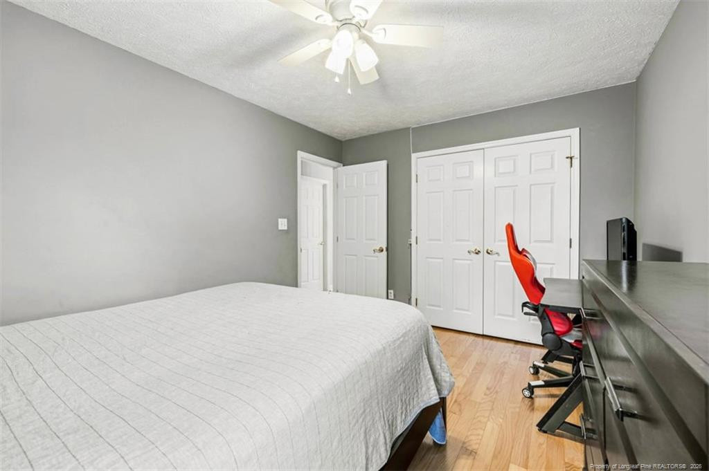 403 Lionshead Road Fayetteville, NC 28311 - Photo 33 of 49 a bedroom with a bed and a chandelier