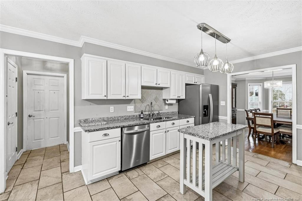 403 Lionshead Road Fayetteville, NC 28311 - Photo 9 of 49 a kitchen that has a lot of white cabinets and stainless steel appliances