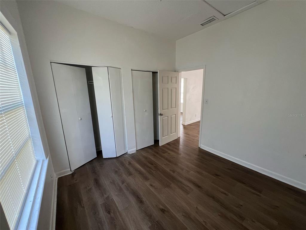 1936 West Cherry Street Tampa, FL 33607 - Photo 9 of 21 a view of an empty room with wooden floor and a window