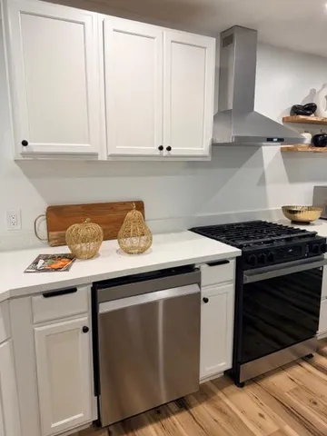 a kitchen with stainless steel appliances granite countertop a sink and a stove