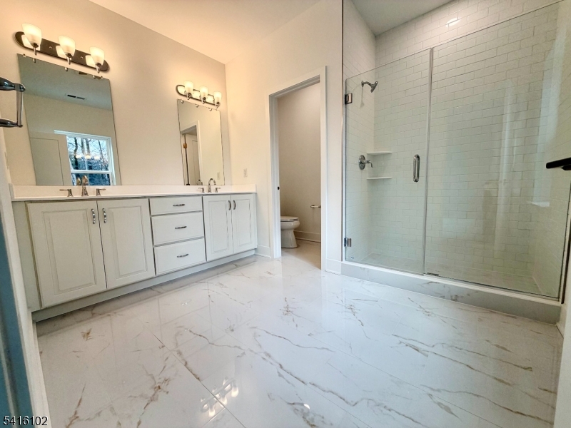 26 Arowana Road Randolph, NJ 07869 - Photo 19 of 26 a spacious bathroom with a mirror a shower and a sink
