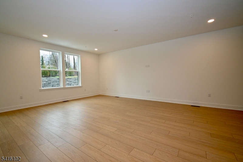 26 Arowana Road Randolph, NJ 07869 - Photo 4 of 26 an empty room with wooden floor and windows