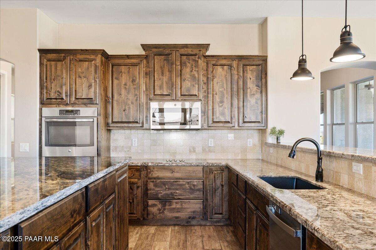 12300 West Slate Road Prescott, AZ 86305 - Photo 11 of 59 a kitchen with stainless steel appliances granite countertop a sink stove and refrigerator