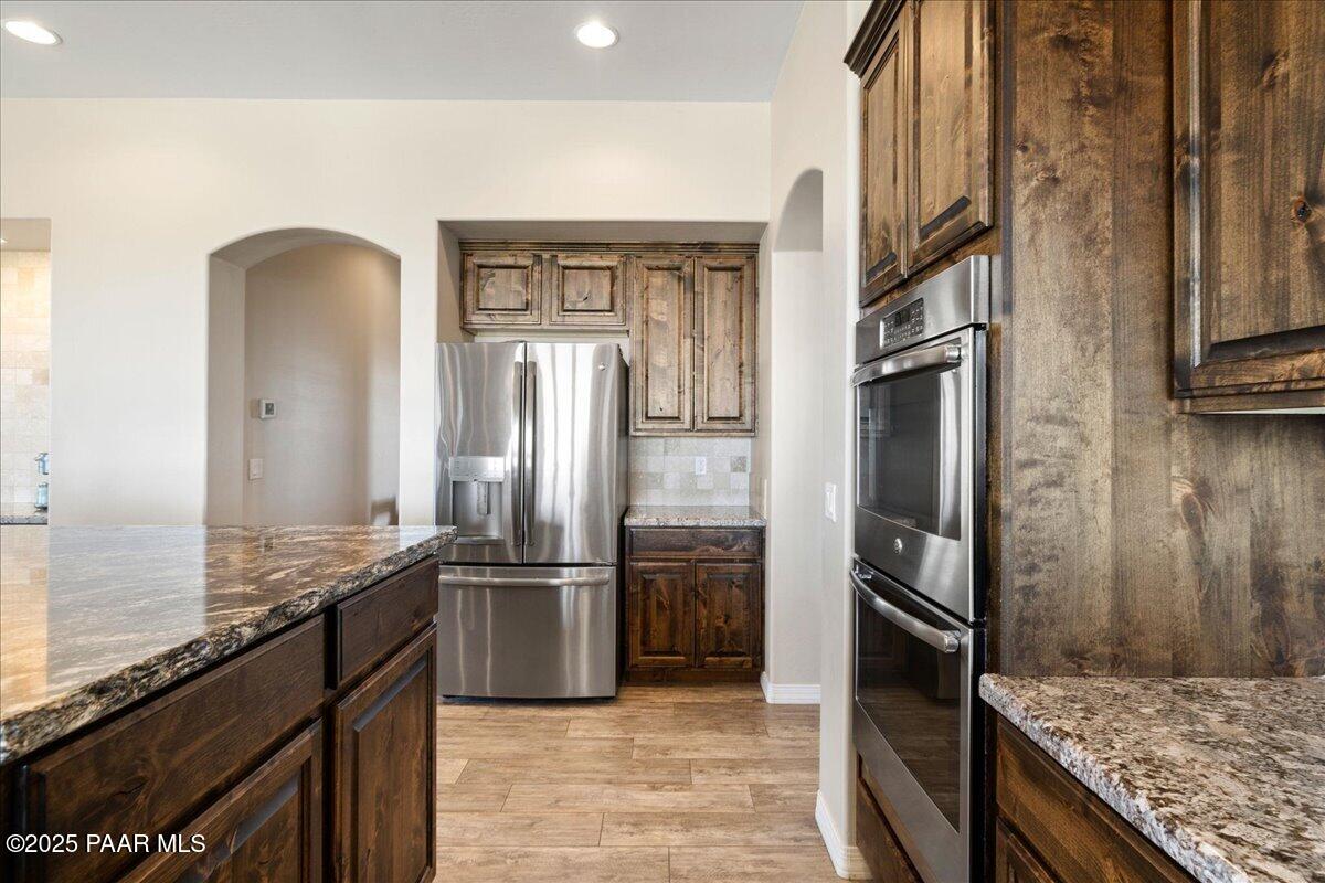 12300 West Slate Road Prescott, AZ 86305 - Photo 12 of 59 a kitchen with stainless steel appliances granite countertop a refrigerator and a sink