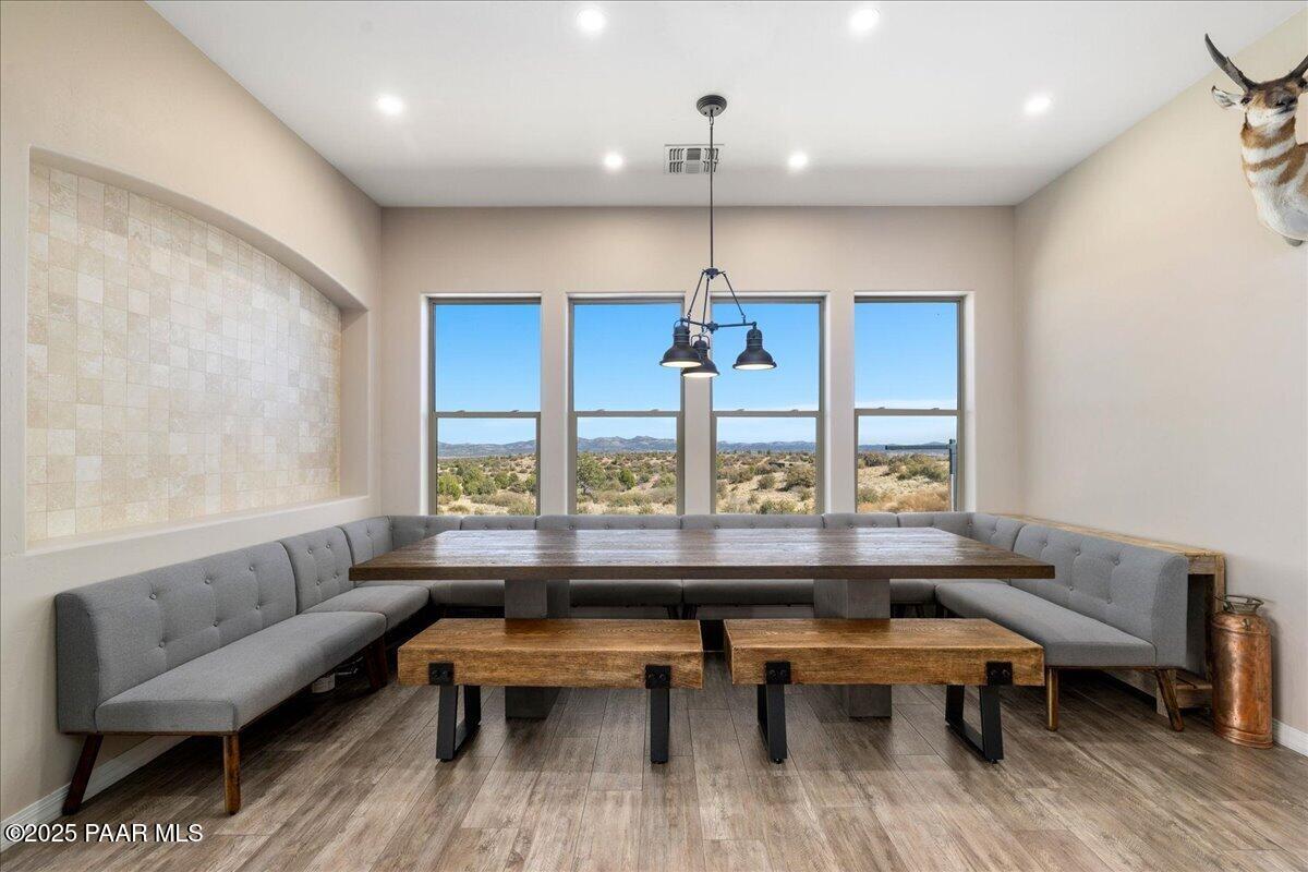 12300 West Slate Road Prescott, AZ 86305 - Photo 15 of 59 a dining room with wooden floor and a chandelier