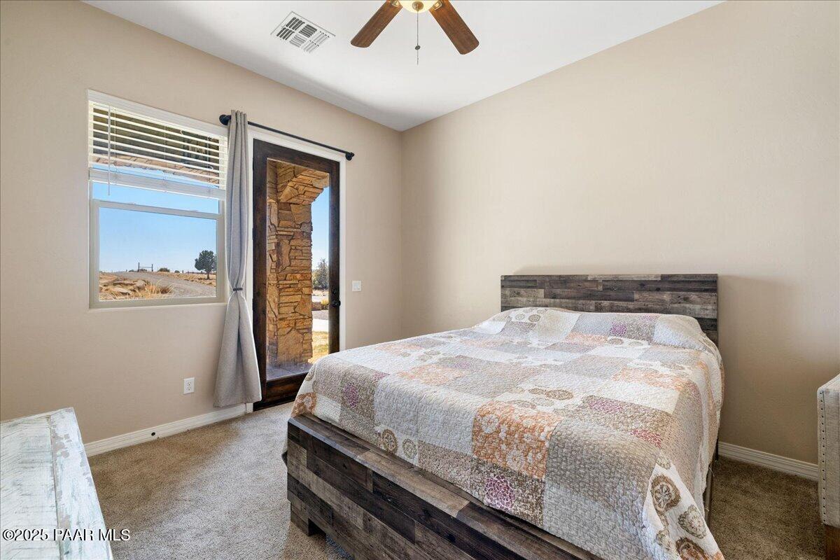 12300 West Slate Road Prescott, AZ 86305 - Photo 22 of 59 a bedroom with a bed and a window