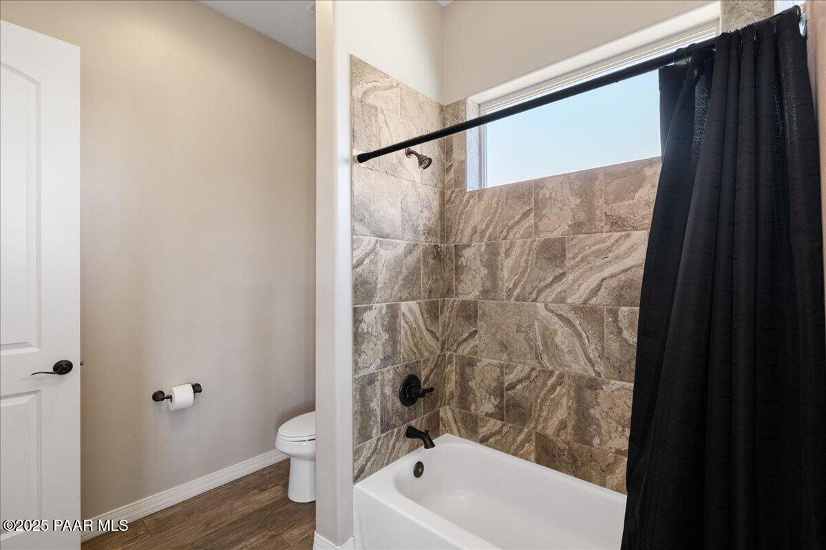 12300 West Slate Road Prescott, AZ 86305 - Photo 26 of 59 a bathroom with a white bath tub and a shower curtain