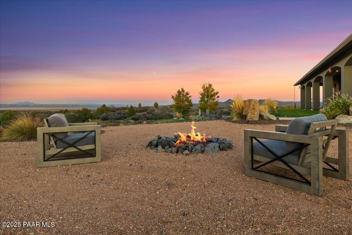 12300 West Slate Road Prescott, AZ 86305 - Photo 35 of 59 a couple of chairs that are sitting in the middle of a lake