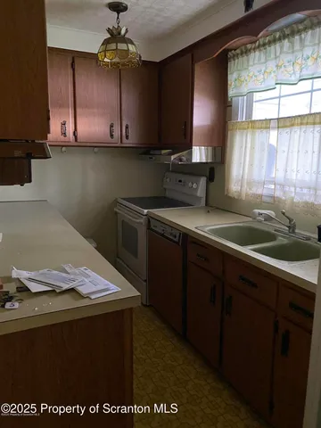 a kitchen with a sink a stove and window