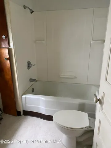 a bathroom with a toilet a sink and bathtub