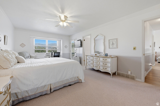 3766 Cardiff Circle Bountiful, UT 84010 - Photo 25 of 46 Carpeted room featuring a large window, a ceiling fan with light fixture, and a neutral two-tone wall treatment