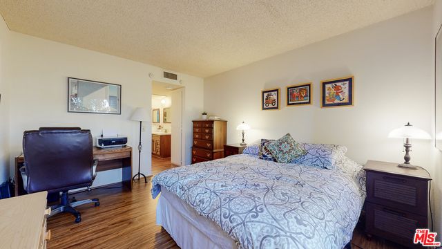 a bedroom with a large bed and a dresser