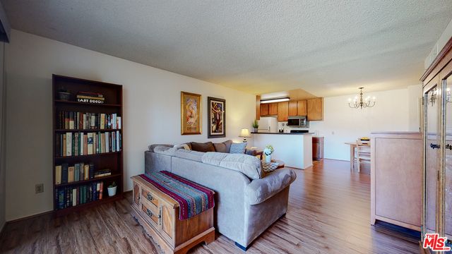a living room with furniture and a book shelf