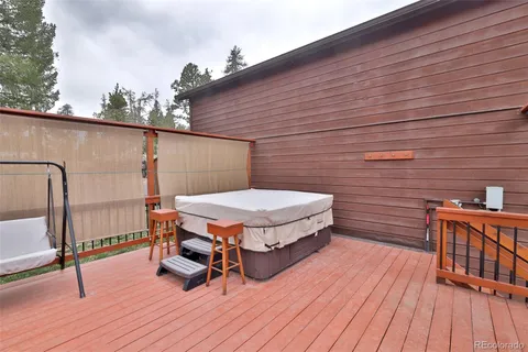 a balcony with furniture and wooden floor