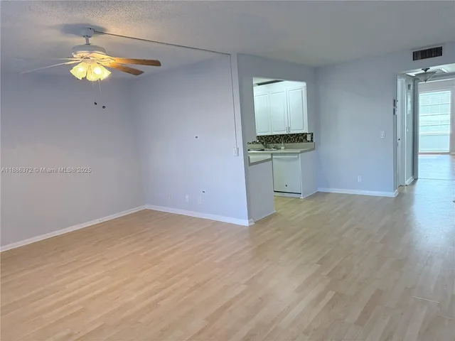 a dining room with furniture and potted plants