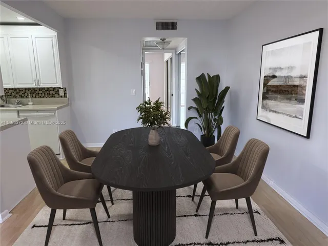 a view of a kitchen with wooden floor and cabinets