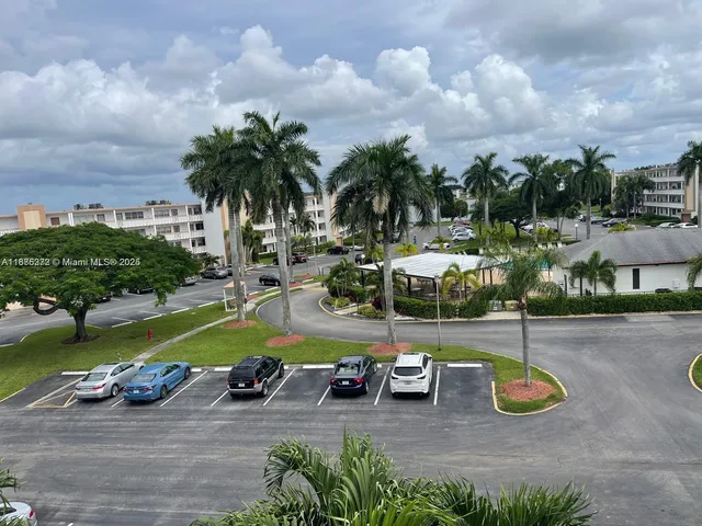 a view of a park with lawn chairs and a fire pit