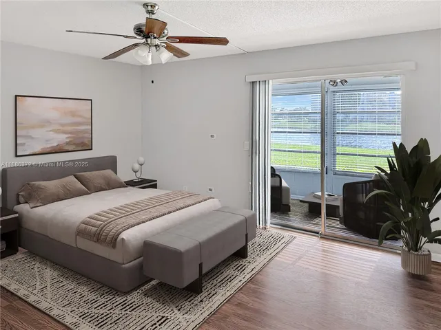 a bedroom with a large bed a chandelier and a window