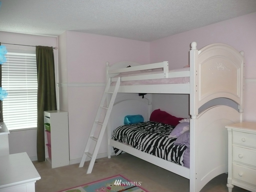 2131 240th Place Southeast Bothell, WA 98021 - Photo 14 of 20 a bedroom with a bed and a painting on the wall