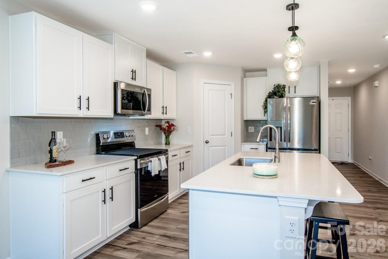 2742 Legacy Ridge Lane Catawba, NC 28609 - Photo 13 of 36 a kitchen with stainless steel appliances kitchen island granite countertop a sink a stove and cabinets