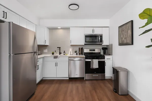 a kitchen with a refrigerator stove and sink