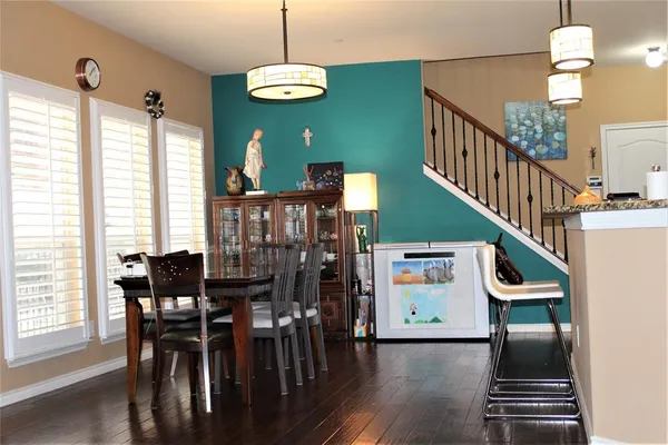 a view of a dining room with furniture window and wooden floor