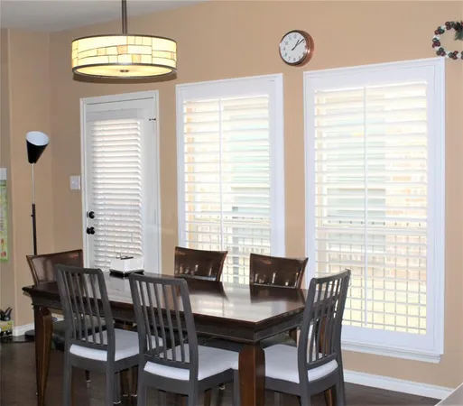 a view of a dining room with furniture and window