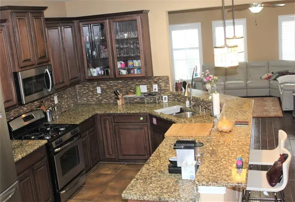 a kitchen with wooden cabinets and a stove top oven