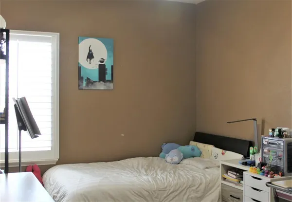 a bedroom with a bed and a window