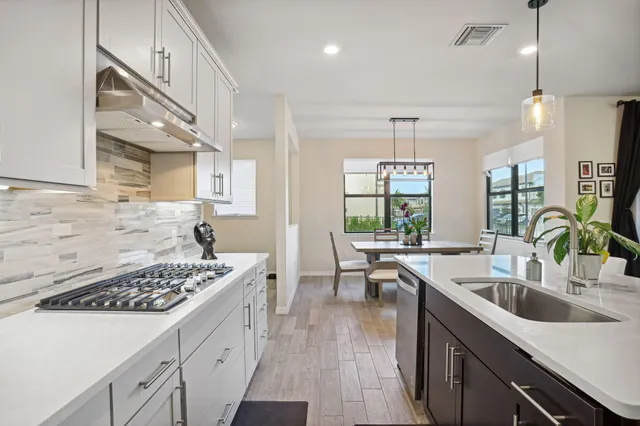 a kitchen with a sink stove and cabinets
