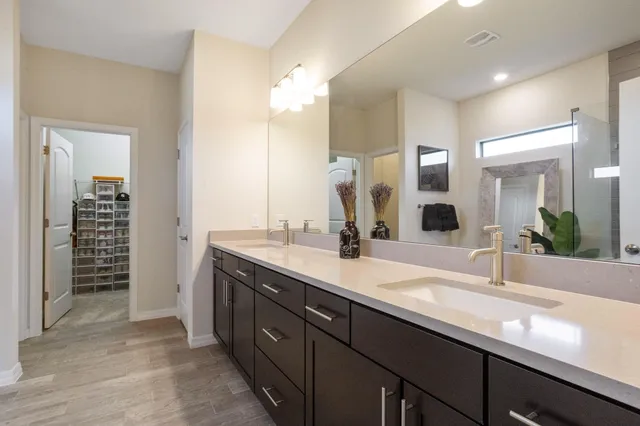 a spacious bathroom with a granite countertop sink and a mirror