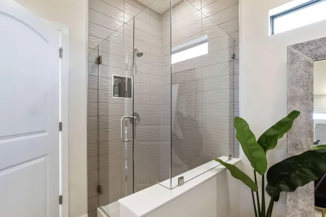 a bathroom with a shower and a tub