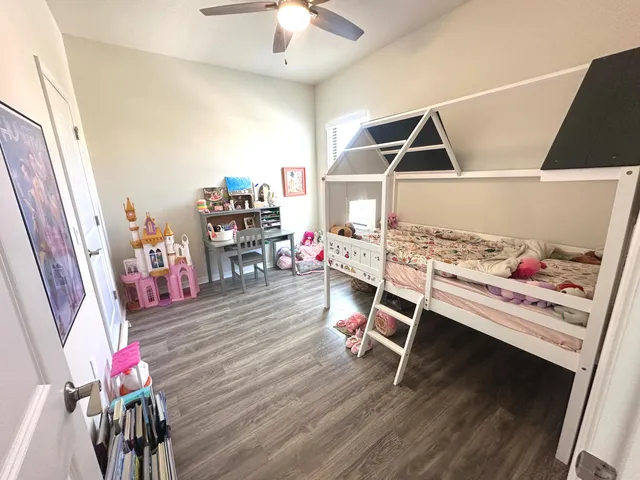 a bedroom with furniture and wooden floor