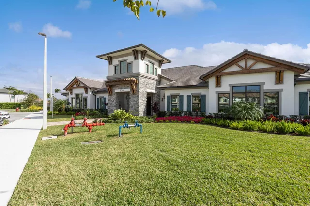 a front view of house with yard and outdoor seating