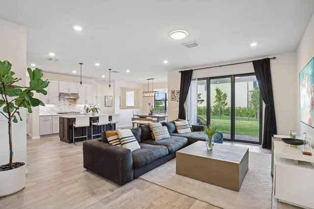 a living room with fireplace furniture and a large window