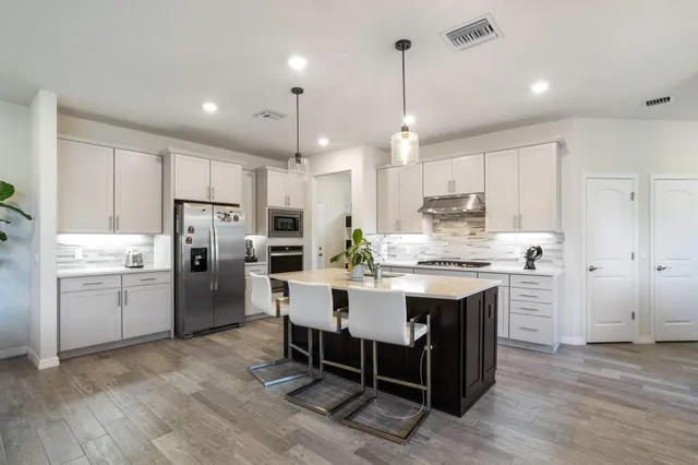a kitchen with refrigerator a sink and cabinets