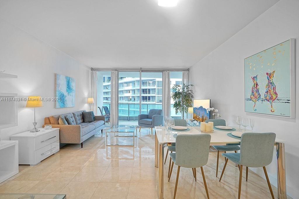 1331 Brickell Bay Drive, Unit 906 Miami, FL 33131 - Photo 1 of 13 a living room with furniture and a large window