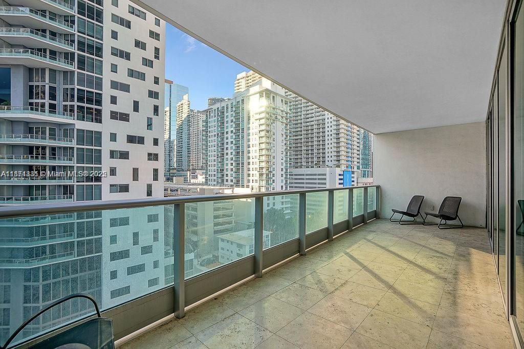 1331 Brickell Bay Drive, Unit 906 Miami, FL 33131 - Photo 12 of 13 a view of a balcony dining table and chair