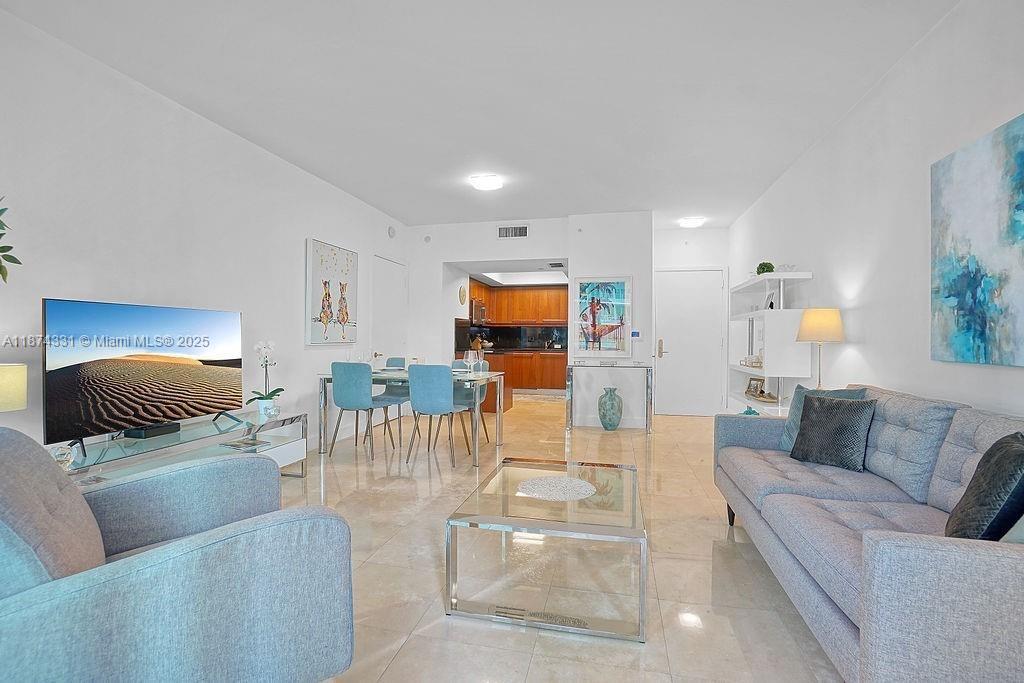 1331 Brickell Bay Drive, Unit 906 Miami, FL 33131 - Photo 3 of 13 a living room with furniture and a flat screen tv