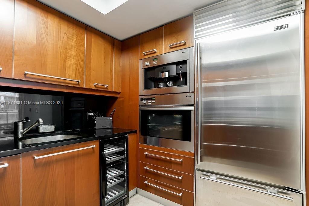 1331 Brickell Bay Drive, Unit 906 Miami, FL 33131 - Photo 5 of 13 a kitchen with granite countertop stainless steel appliances and cabinets