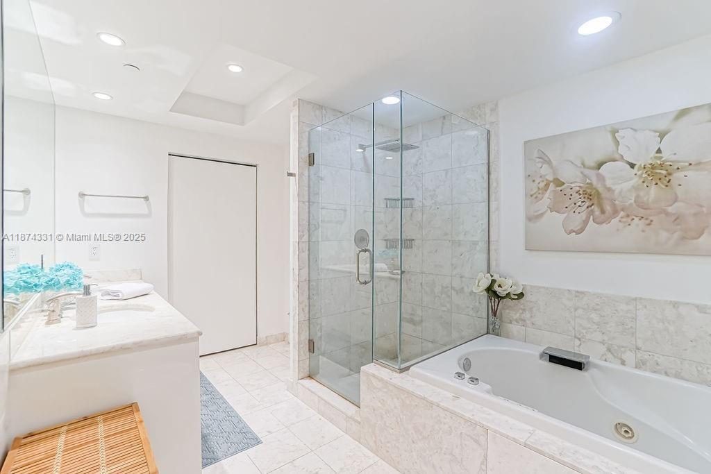 1331 Brickell Bay Drive, Unit 906 Miami, FL 33131 - Photo 8 of 13 a bathroom with a tub sink and mirror